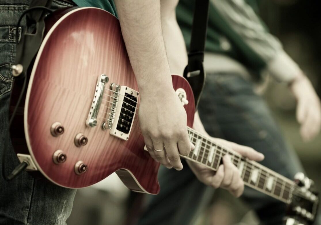 playing sunburst les paul style guitar